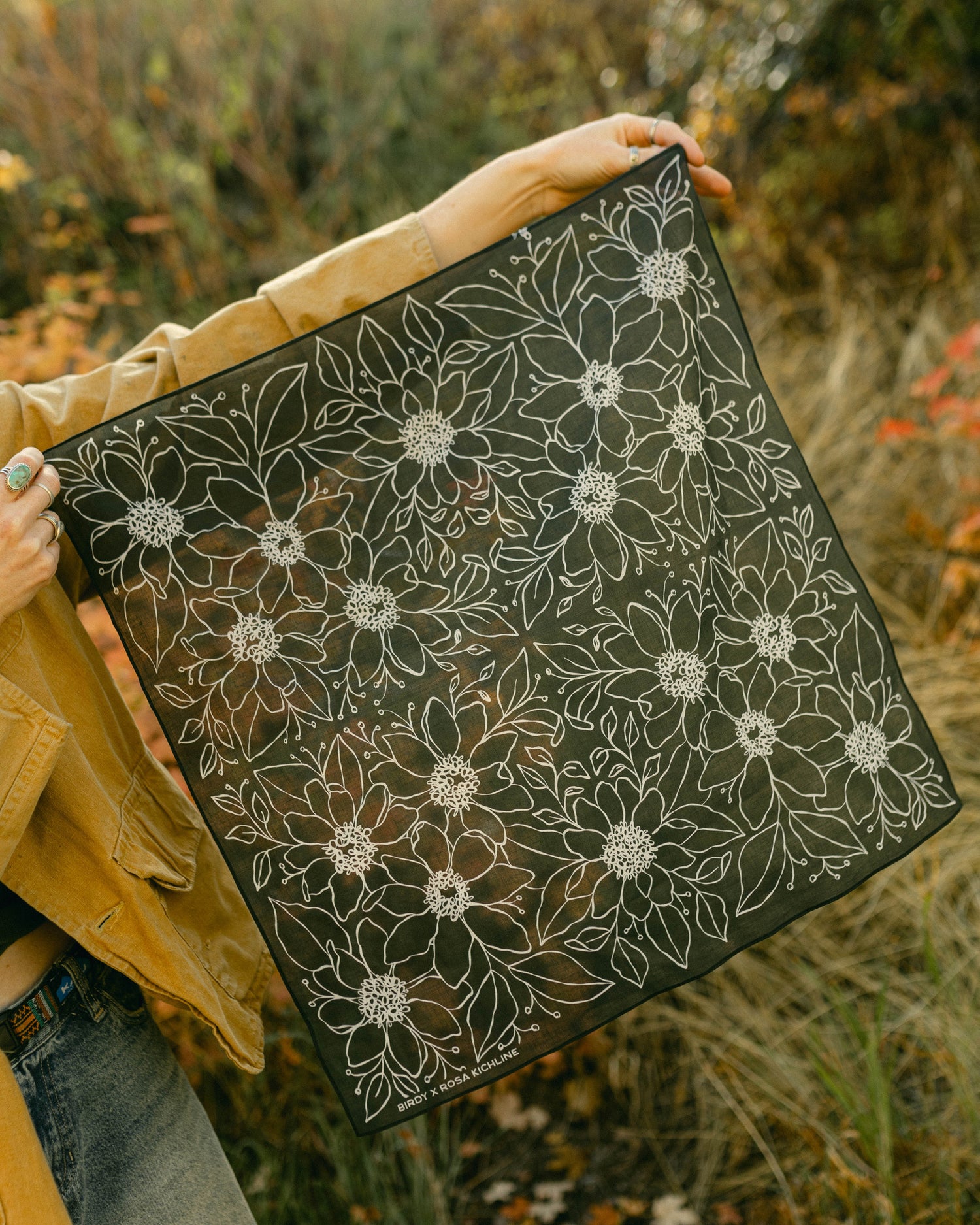Monochromatic Rosa Bandana displayed outdoors, featuring a black-and-white floral design on soft cotton.