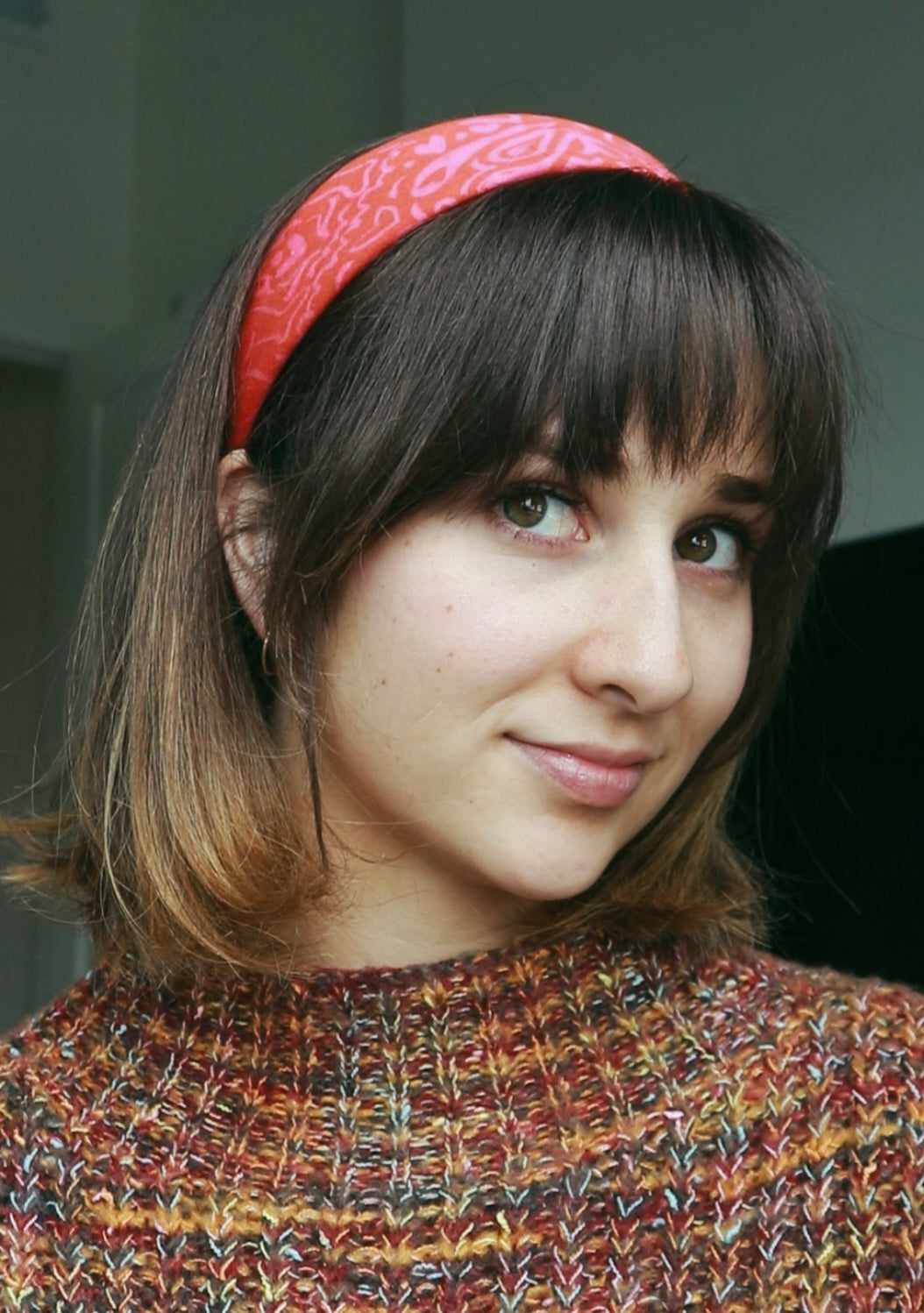 girl with bangs wearing red bandana as a headband