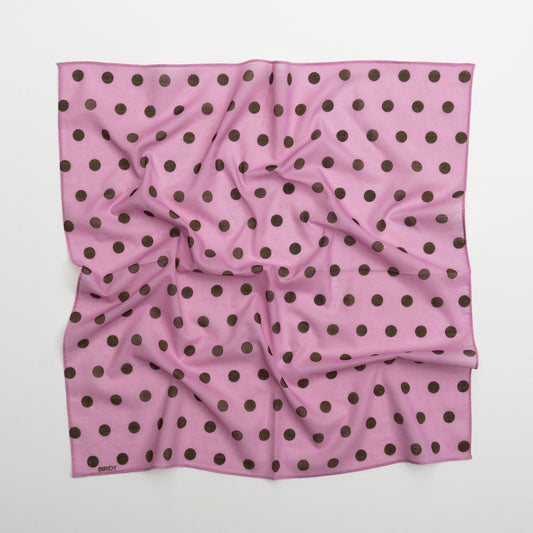 A square pink scarf with a repeating pattern of dark brown polka dots, laid flat on a light gray background.