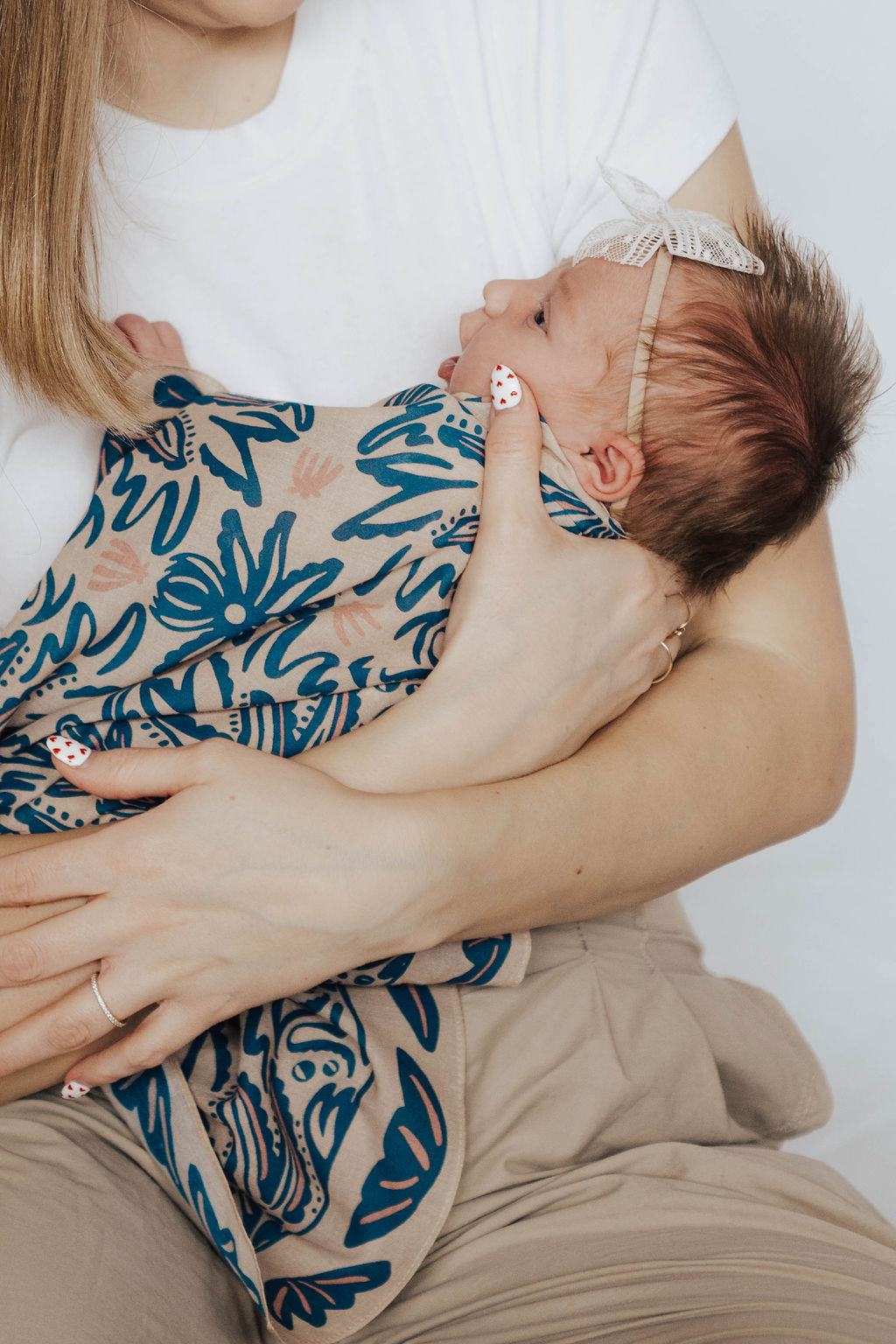 newborn wearing the sofia bandana as a swaddle 