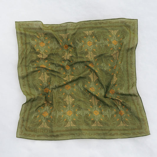 the green daphne bandana with various shades of green and a pop of yellow