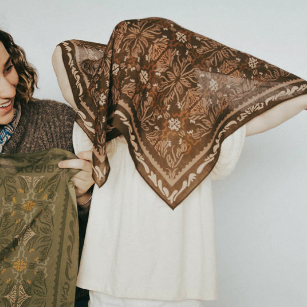 toddler playing with the brown mabel bandana